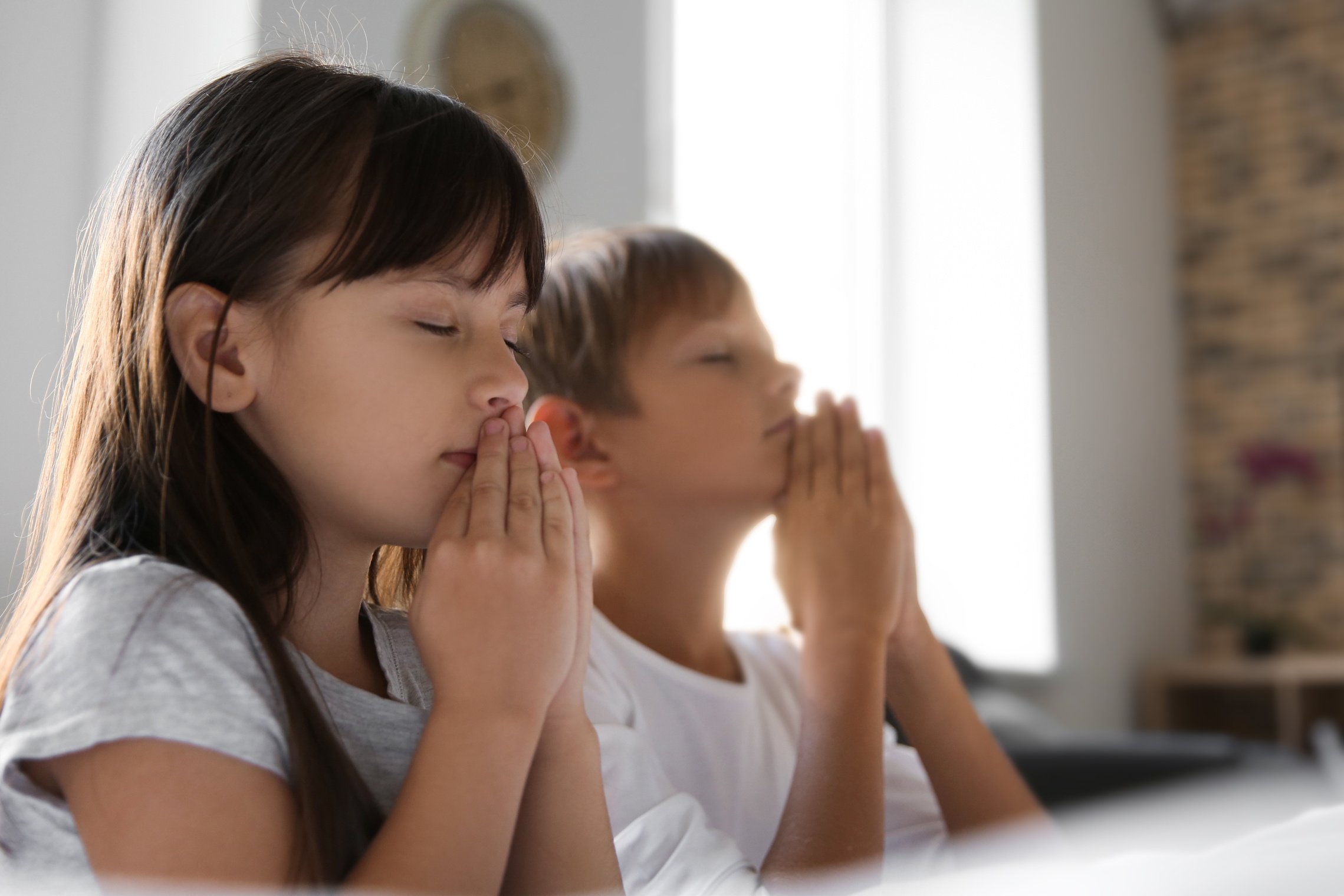 Children Praying on Bed at Home